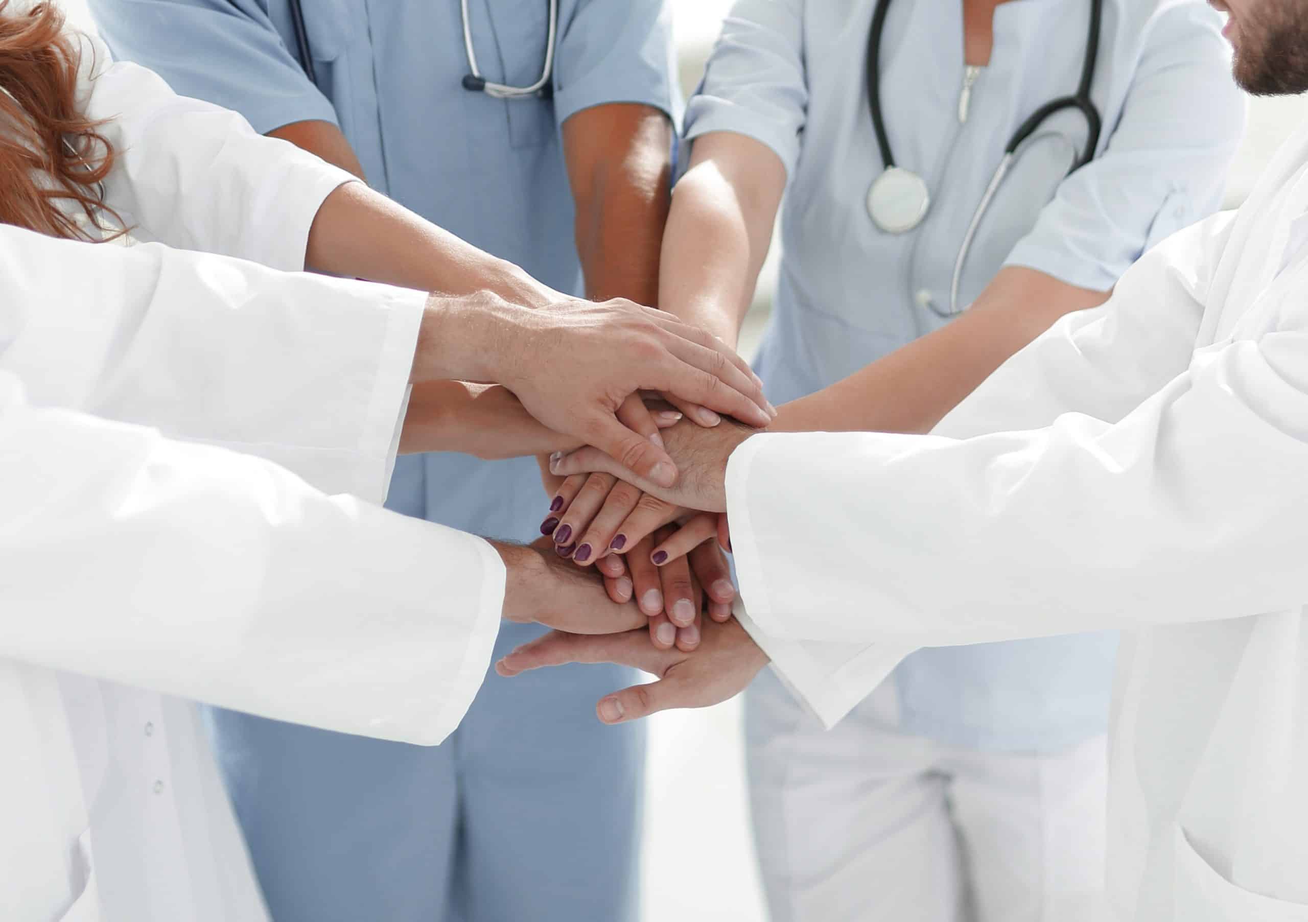 Doctors and nurses stacking hands. concept of mutual aid
